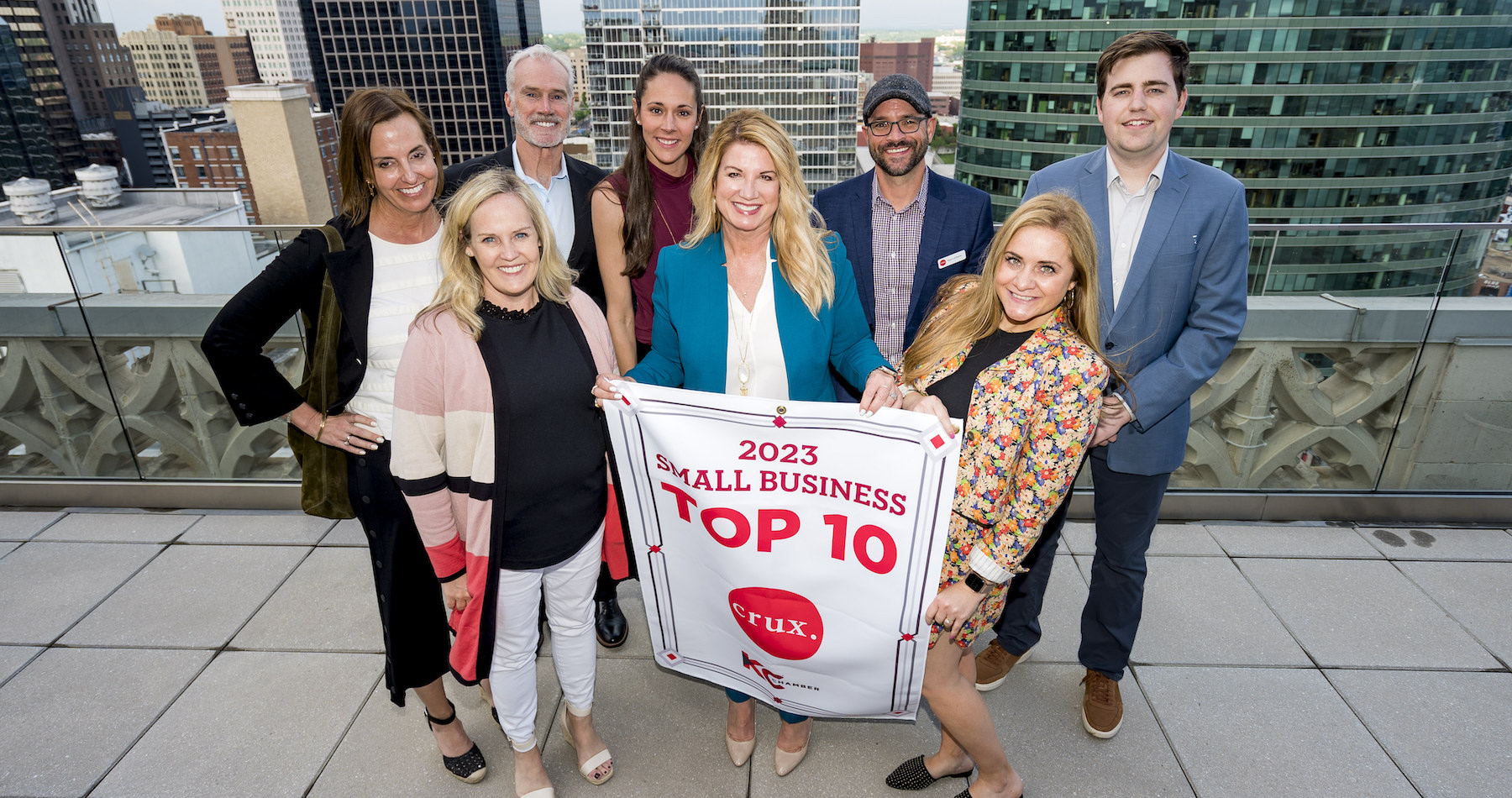 member of team crux holding Top 10 Small Business banner